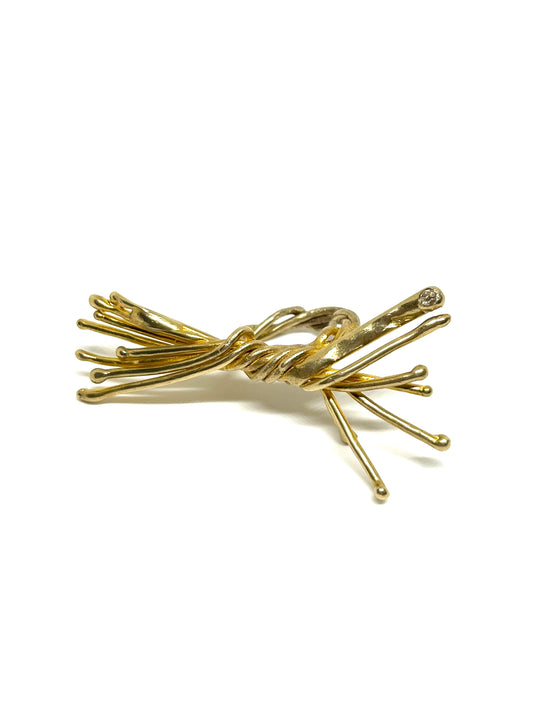 Bow in bronze with natural diamond