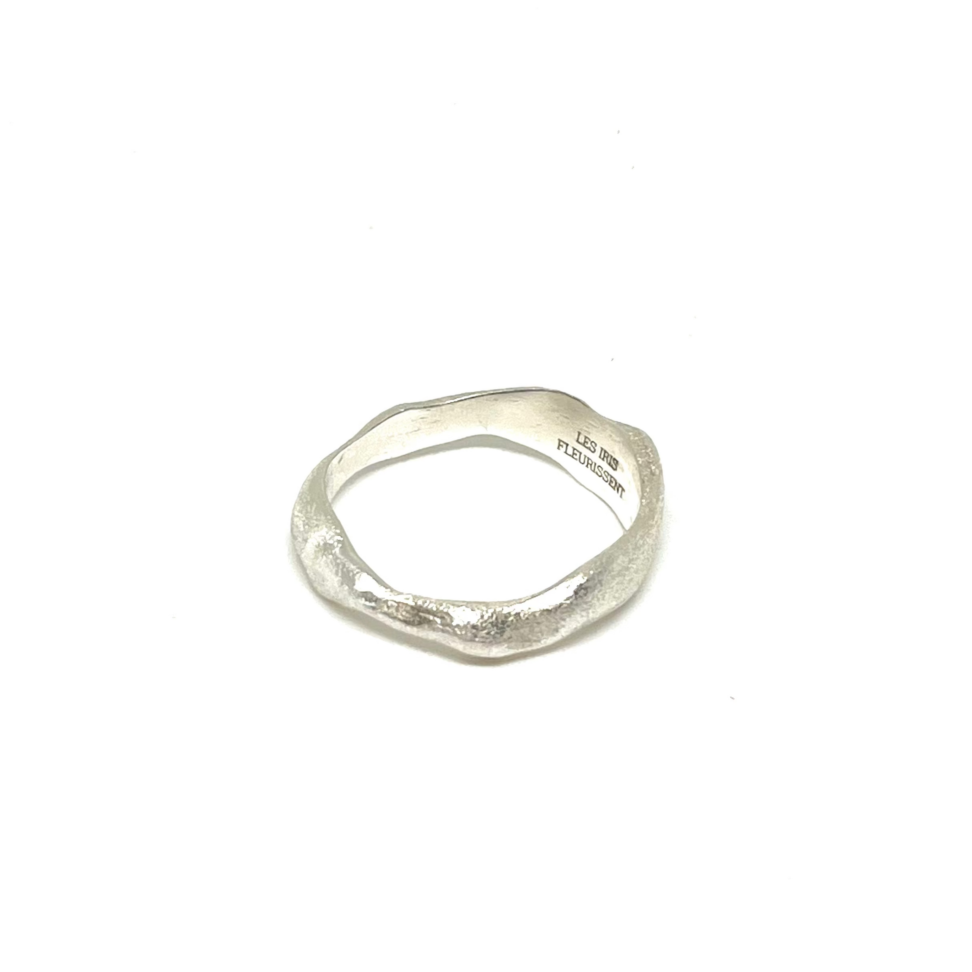 A textured, organic-shaped silver ring with a hammered finish, shown on a plain white background.
