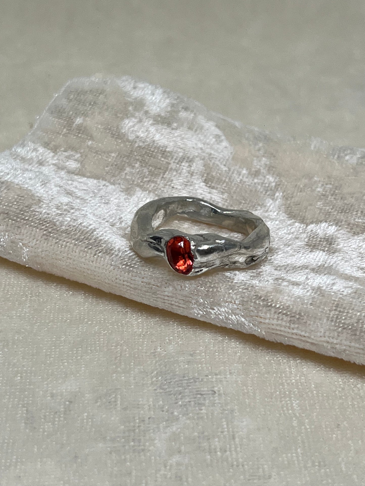 Abstract ring with red topaz